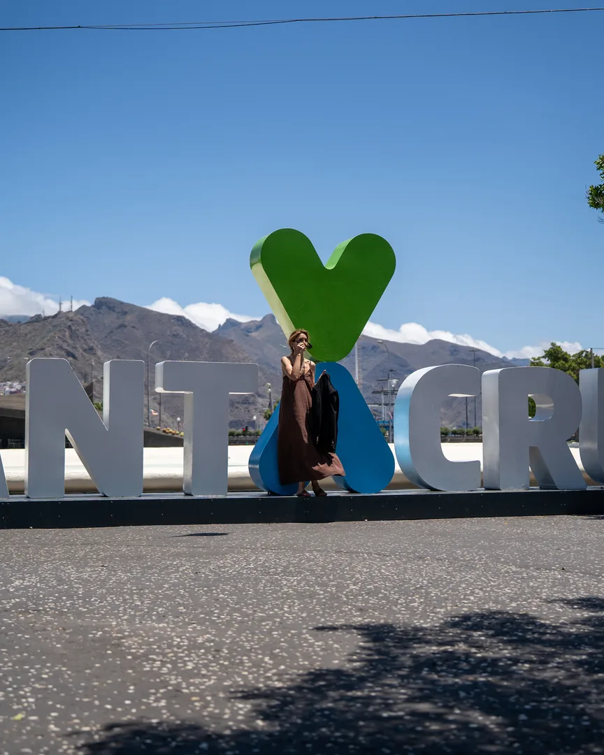 Donna in piedi davanti a una grande scultura di lettere decorative con un cuore